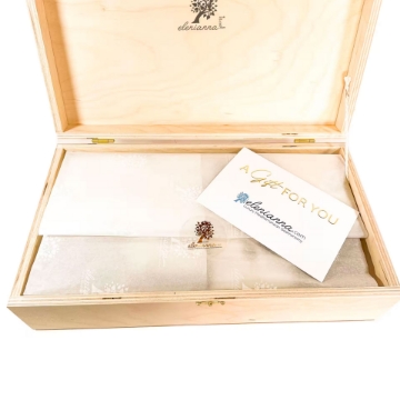 Natural wooden gift box with lid and clasp containing wine and chocolate Natural wooden gift box with lid and clasp containing wine and chocolate