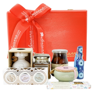 Red pine wooden gift box with a swing lid filled with Greek gourmet food products. Red pine wooden gift box with a swing lid filled with Greek gourmet food products.