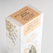 Detailed view of the Mouriki Organic Herbal Blend label showing the Greek and English ingredients including Cretan dittany and mountain tea with a focus on premium gold-foiled botanical illustrations.