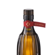 Detailed view of the red and gold "Limited Edition" neck seal on a Corinto Manaki Extra Virgin Olive Oil bottle, signaling premium quality and authenticity.